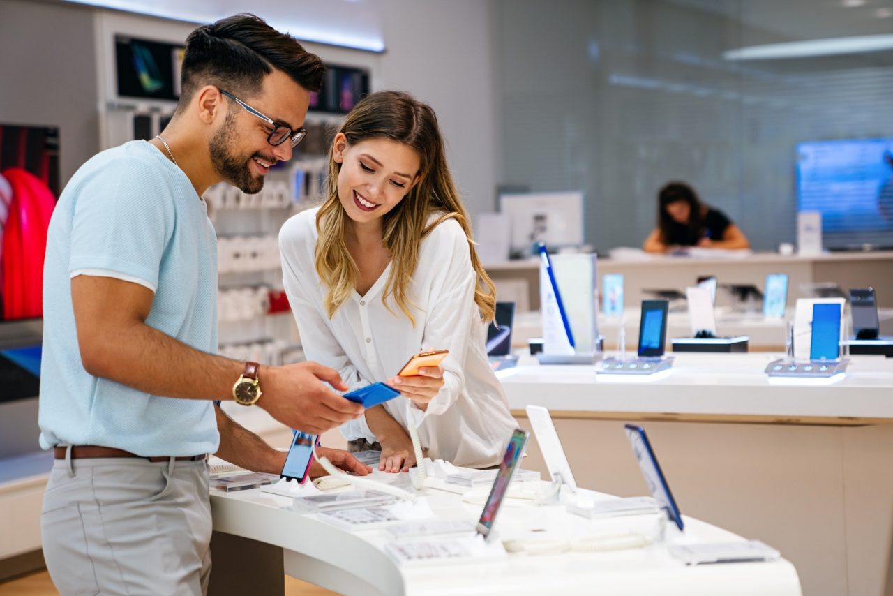 Home 21 shopping a new digital device happy couple buying a smartphone in store